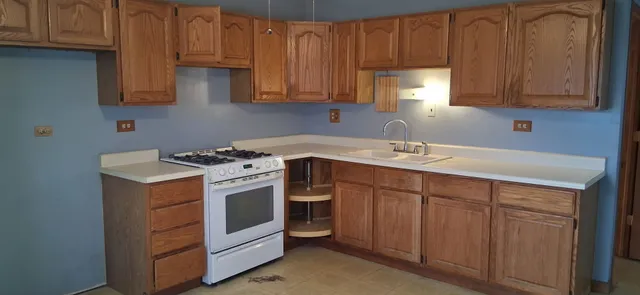 a kitchen with stainless steel appliances granite countertop a sink stove and cabinets