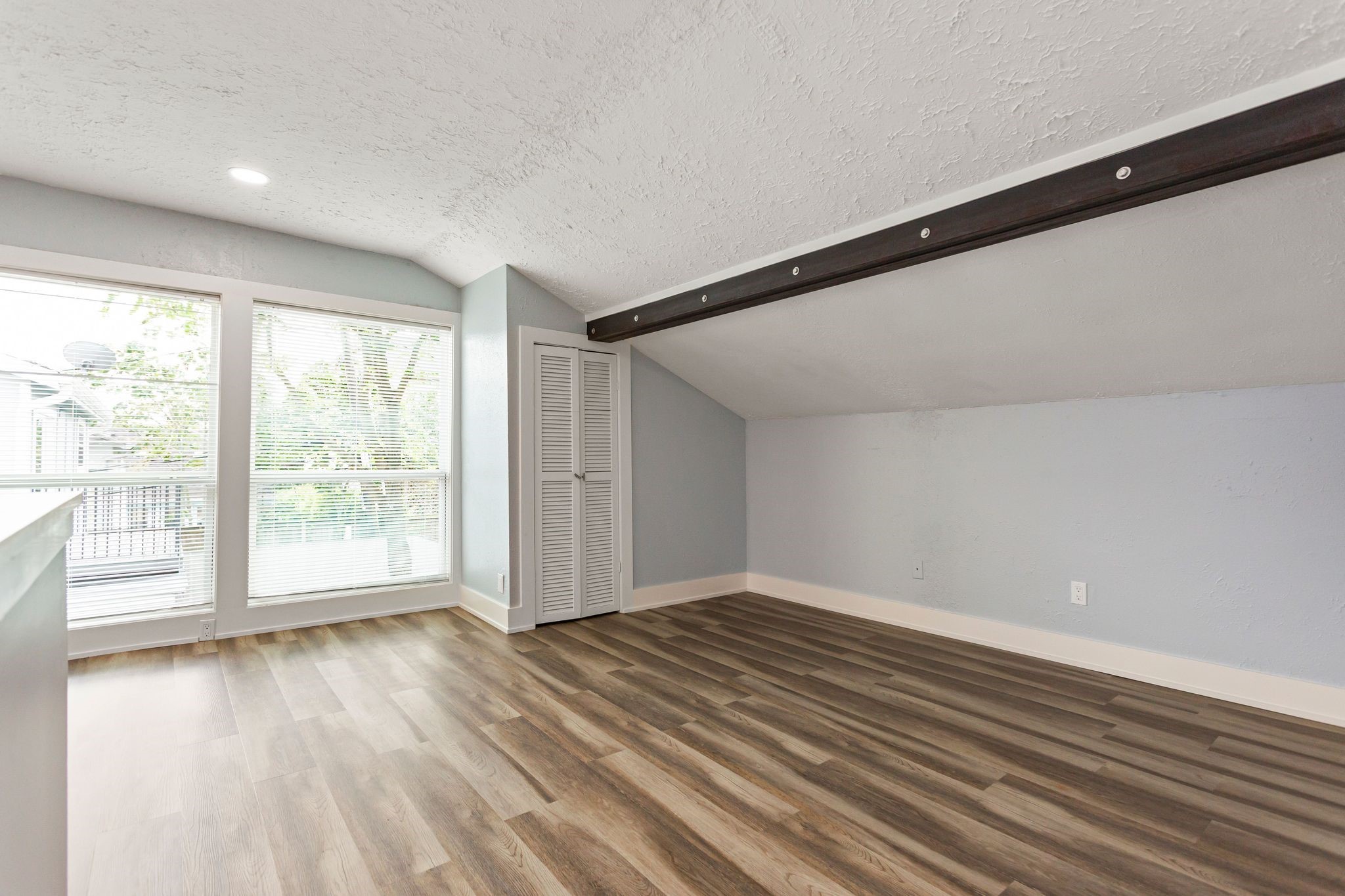 2005 Portsmouth Street, Unit B Houston, TX 77098 - Photo 19 of 24 a view of an empty room with wooden floor and a window