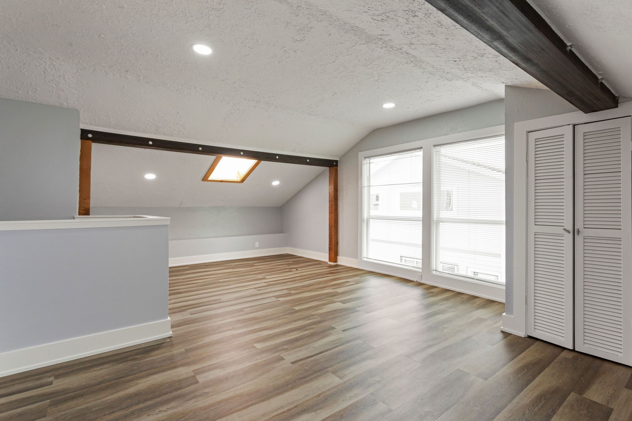 2005 Portsmouth Street, Unit B Houston, TX 77098 - Photo 22 of 24 a view of an empty room with wooden floor and a window