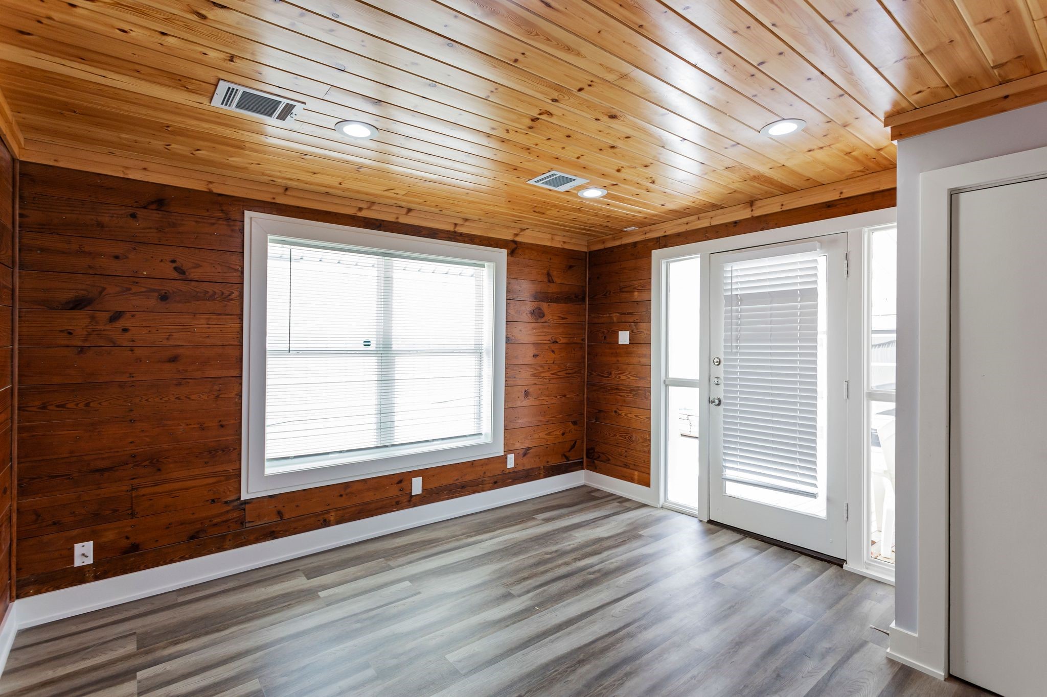 2005 Portsmouth Street, Unit B Houston, TX 77098 - Photo 8 of 24 an empty room with wooden floor and windows