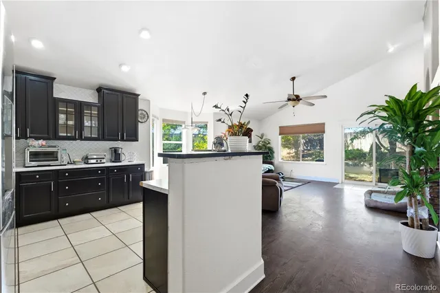 a large kitchen with kitchen island granite countertop lots of counter top space and stainless steel appliances