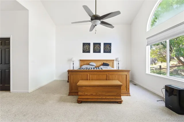 a bedroom with bed and window