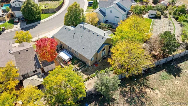 an aerial view of a house with a yard and garden