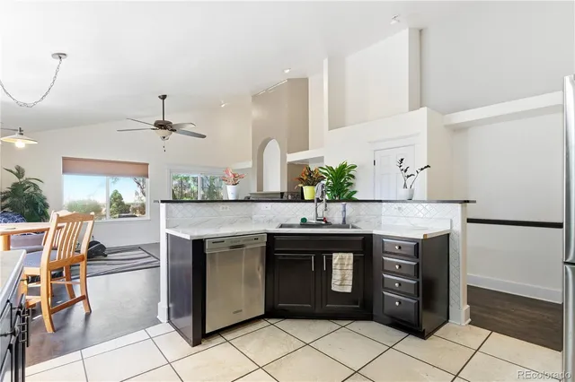 a kitchen with stainless steel appliances granite countertop a sink and a refrigerator