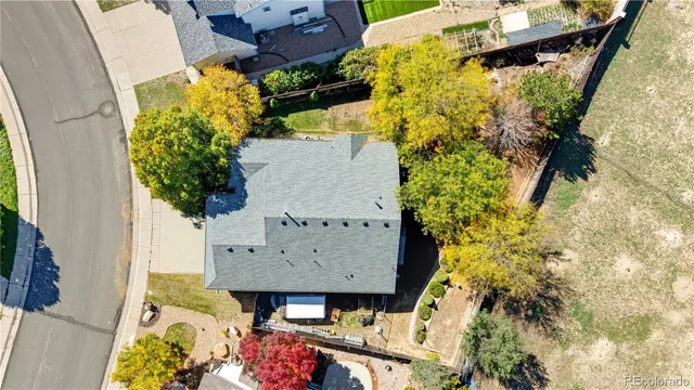 an aerial view of a house with a yard basket ball court