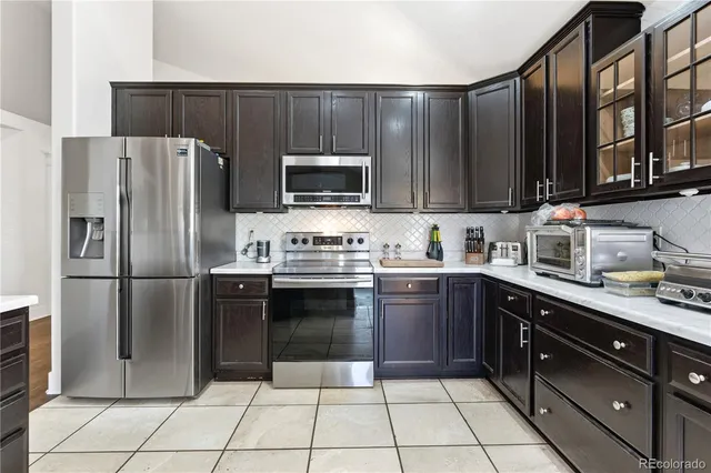 a kitchen with a refrigerator sink and microwave