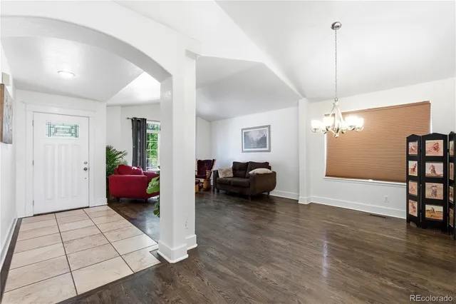 a living room with furniture and a chandelier