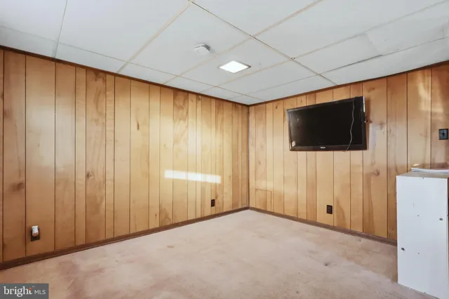 a view of a livingroom with wooden floor and a flat screen tv