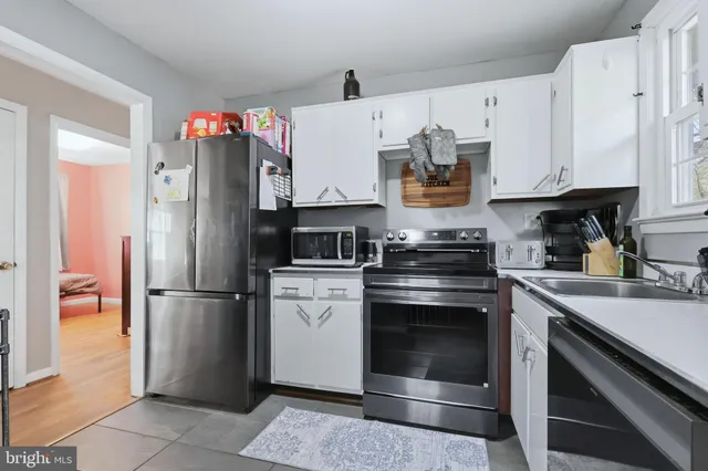 a kitchen with stainless steel appliances granite countertop a refrigerator stove and sink