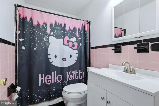 a bathroom with a sink mirror and toilet
