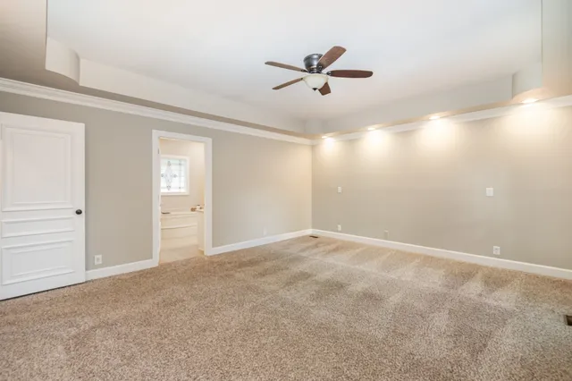 a view of a livingroom with a ceiling fan and window