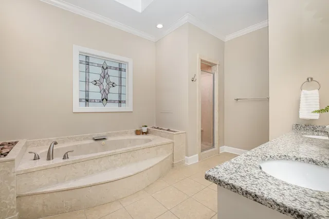 a spacious bathroom with a granite countertop tub sink and mirror