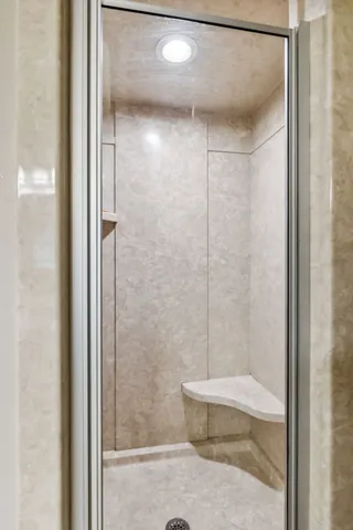 a bathroom with a shower and a toilet