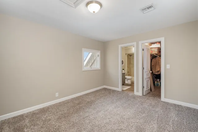 a bathroom with a granite countertop sink toilet mirror and shower