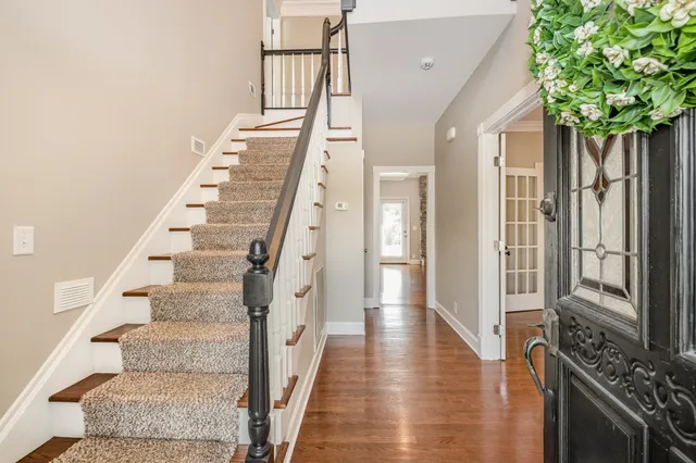 a view of an entryway with wooden floor and stairs