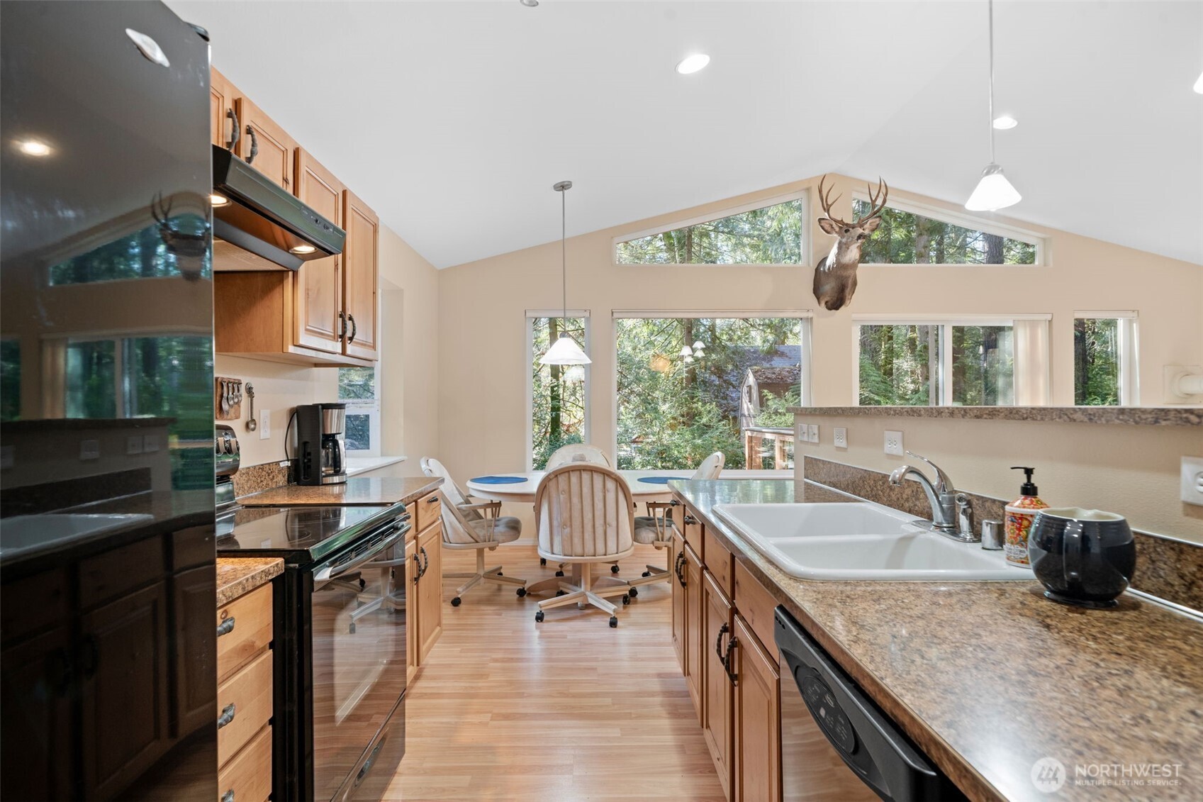 664 East Portage Road Shelton, WA 98584 - Photo 17 of 40 a kitchen with granite countertop a sink stove and cabinets