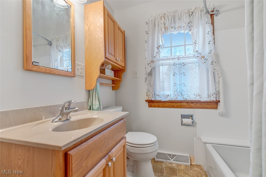 43800 Middle Ridge Road Lorain, OH 44053 - Photo 17 of 31 Full bath featuring vanity, light tile patterned floors, and shower / bathtub combination with updated fixtures