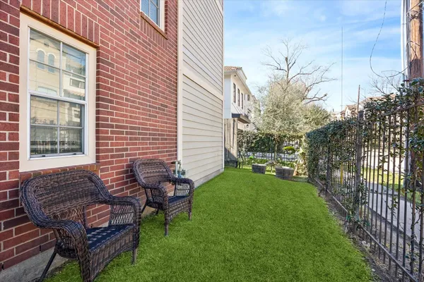 a view of a chair and table in backyard of the house