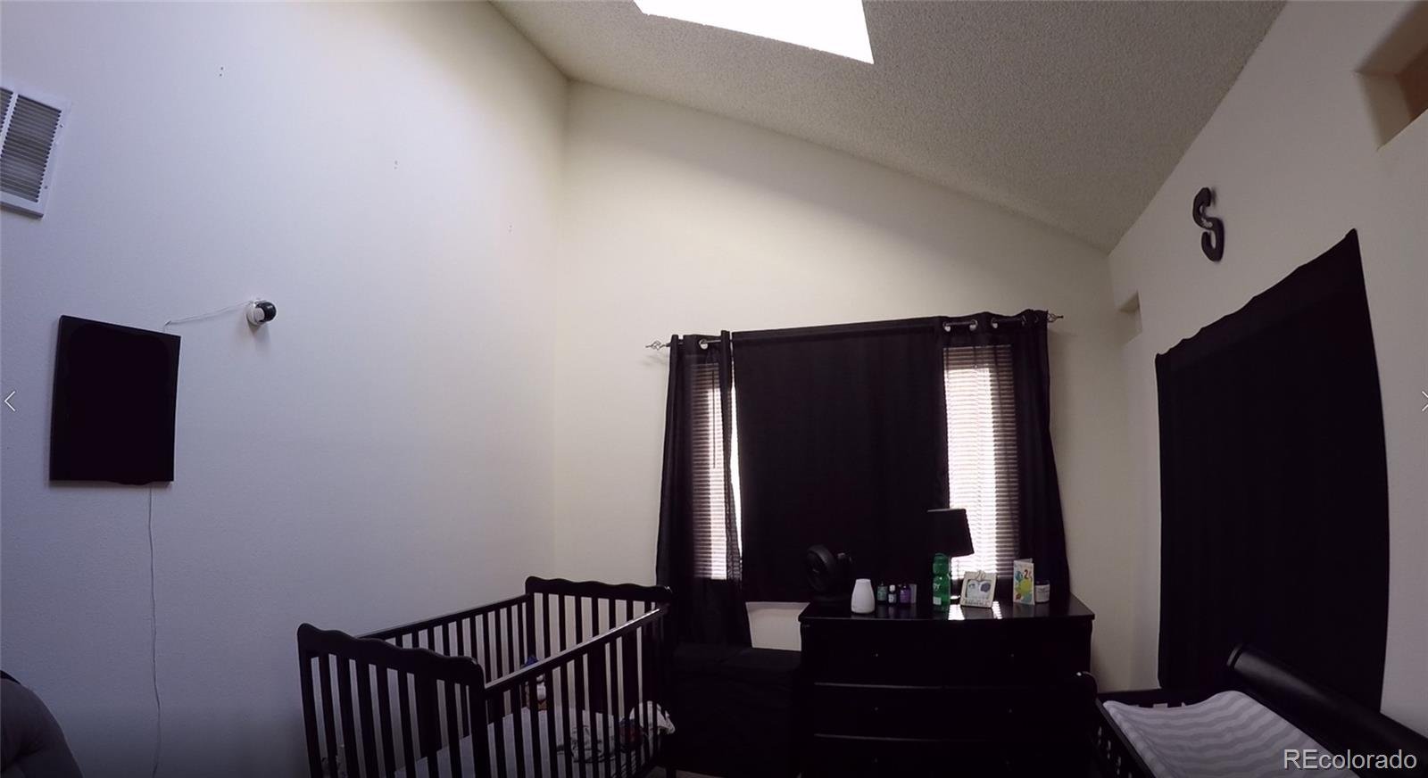 8148 Sweet Water Road Lone Tree, CO 80124 - Photo 9 of 13 a view of hallway with furniture and a flat screen tv