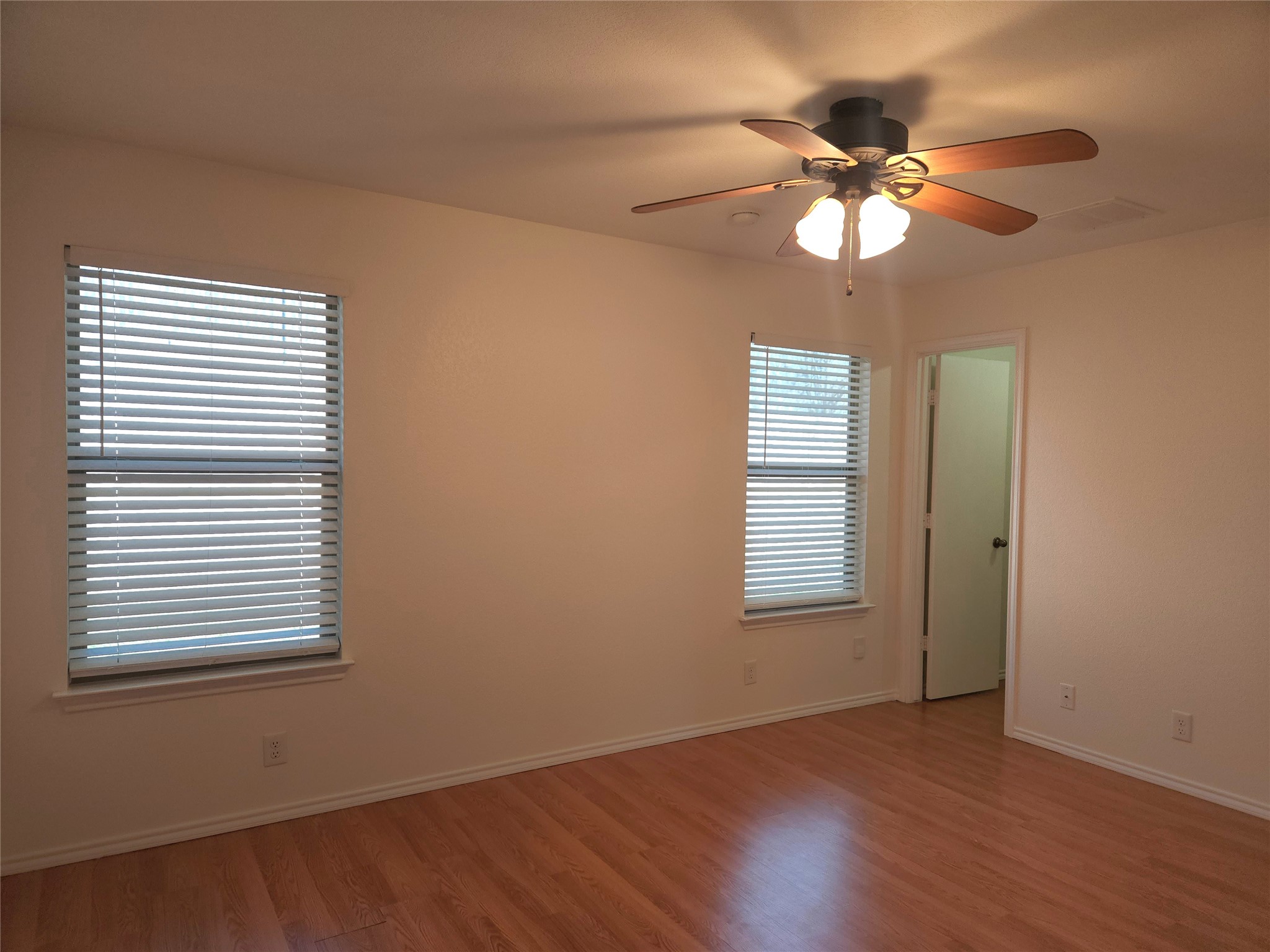 273 Tower Drive Kyle, TX 78640 - Photo 7 of 13 a view of an empty room with wooden floor and a window