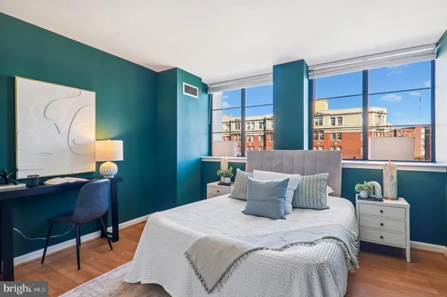 a bedroom with a bed and wooden floor