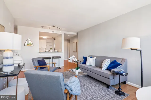 a bathroom with a granite countertop toilet a sink a mirror and shower curtain