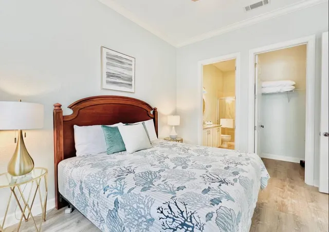 a bedroom with a large bed and a chandelier