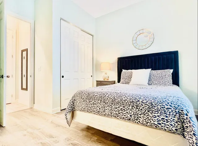 a bedroom with a large bed and a window