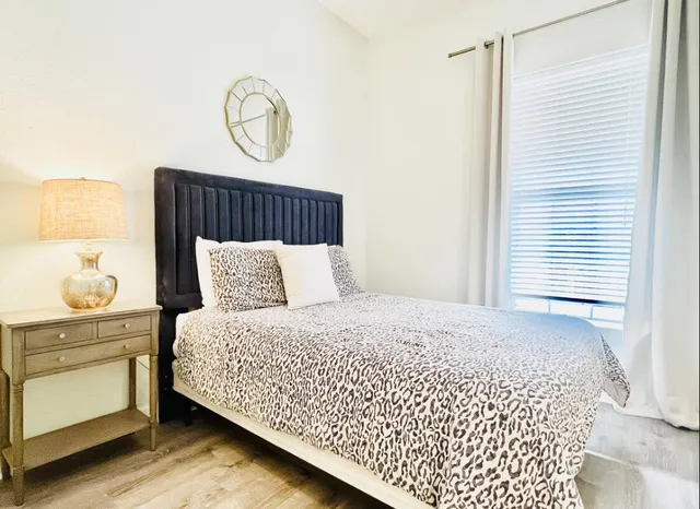 a bedroom with a bed and window