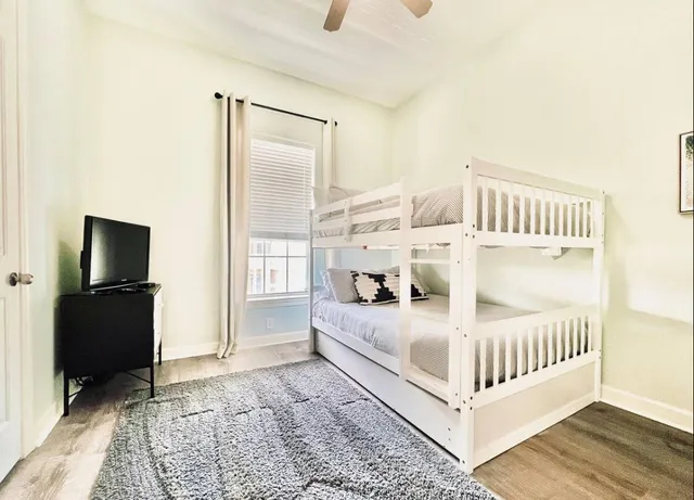 a bedroom with furniture and baby crib