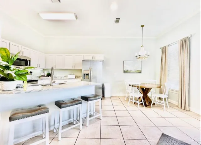 a view of kitchen with cabinets and outdoor seating