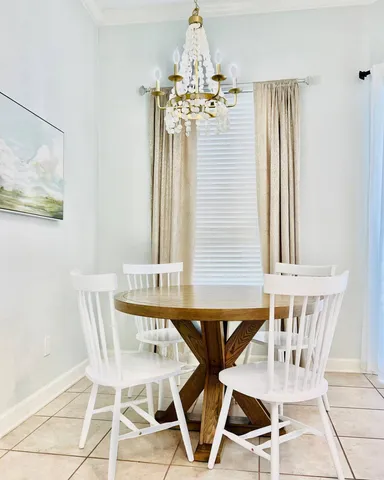 a view of a dining room with furniture and chandelier