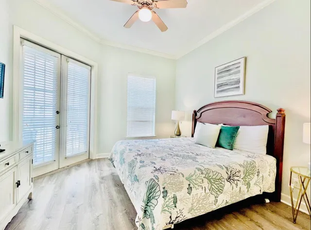 a bedroom with a large bed and a chandelier
