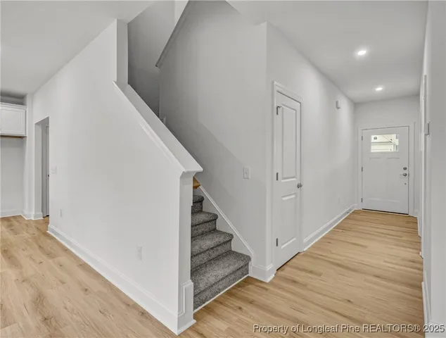a view of an entryway with wooden floor