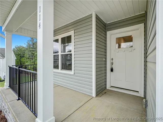 a view of a porch with a door and wooden floor