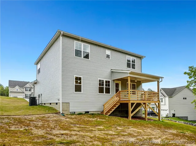a view of a house with a backyard