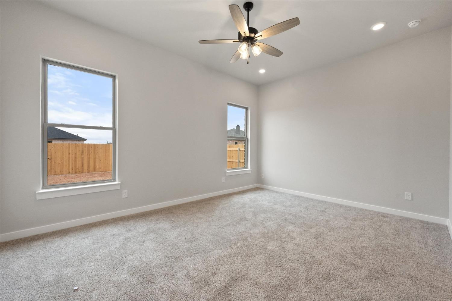 7435 29th Street Lubbock, TX 79407 - Photo 12 of 22 an empty room with windows and fan