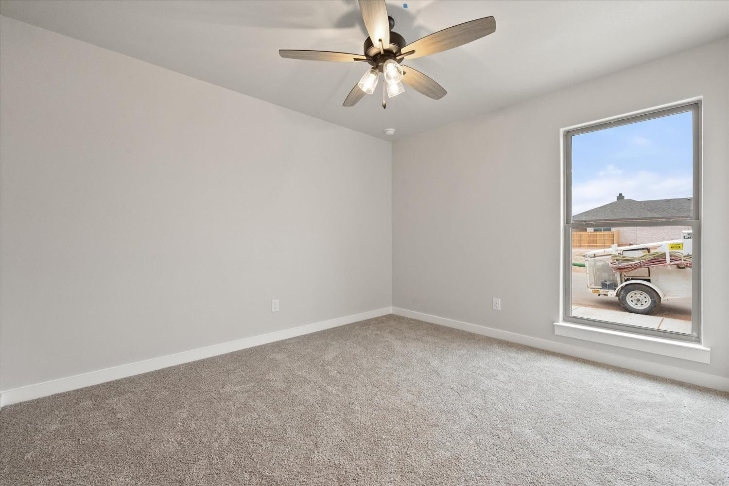 7435 29th Street Lubbock, TX 79407 - Photo 19 of 22 an empty room with windows and ceiling fan