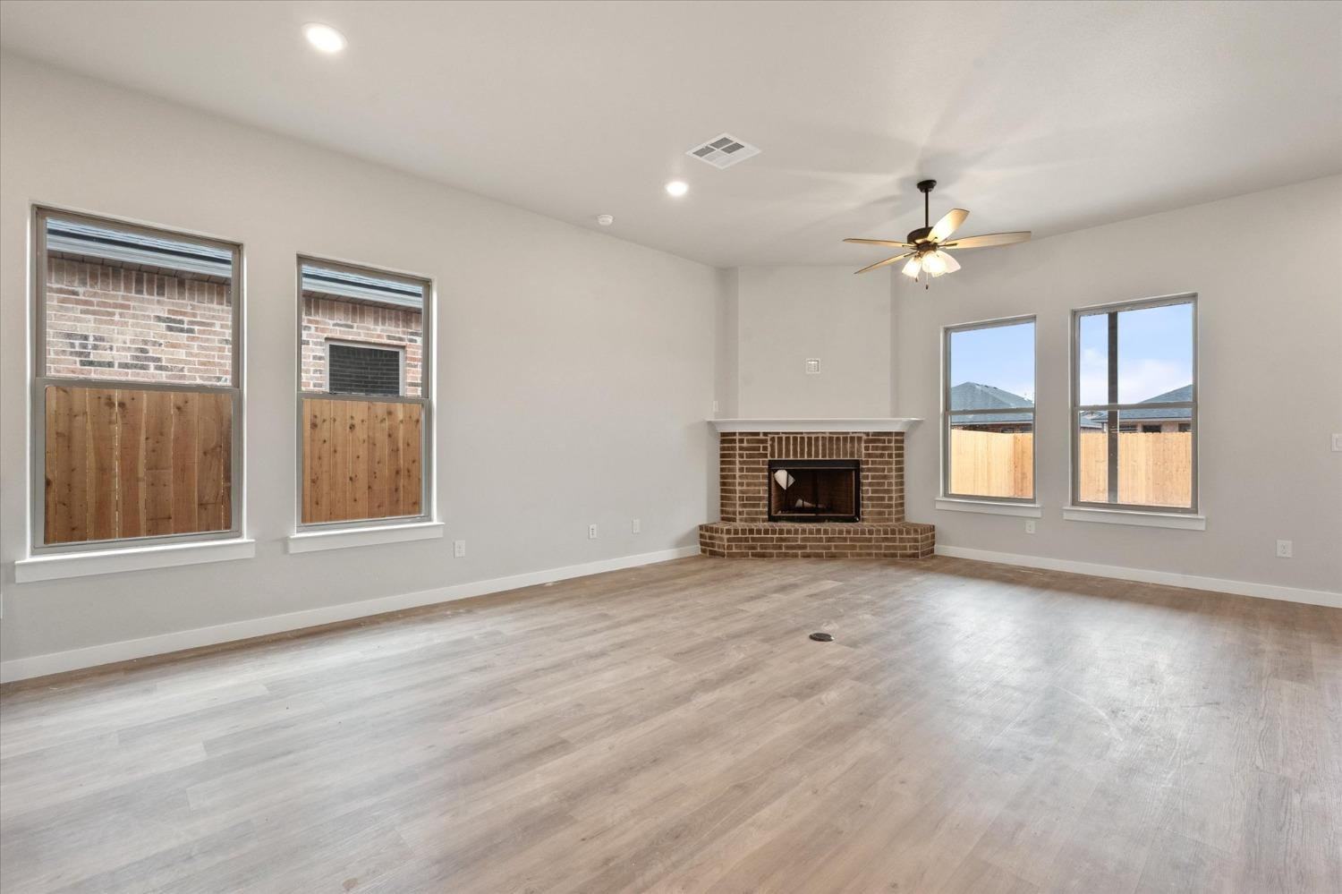 7435 29th Street Lubbock, TX 79407 - Photo 8 of 22 an empty room with windows and fireplace