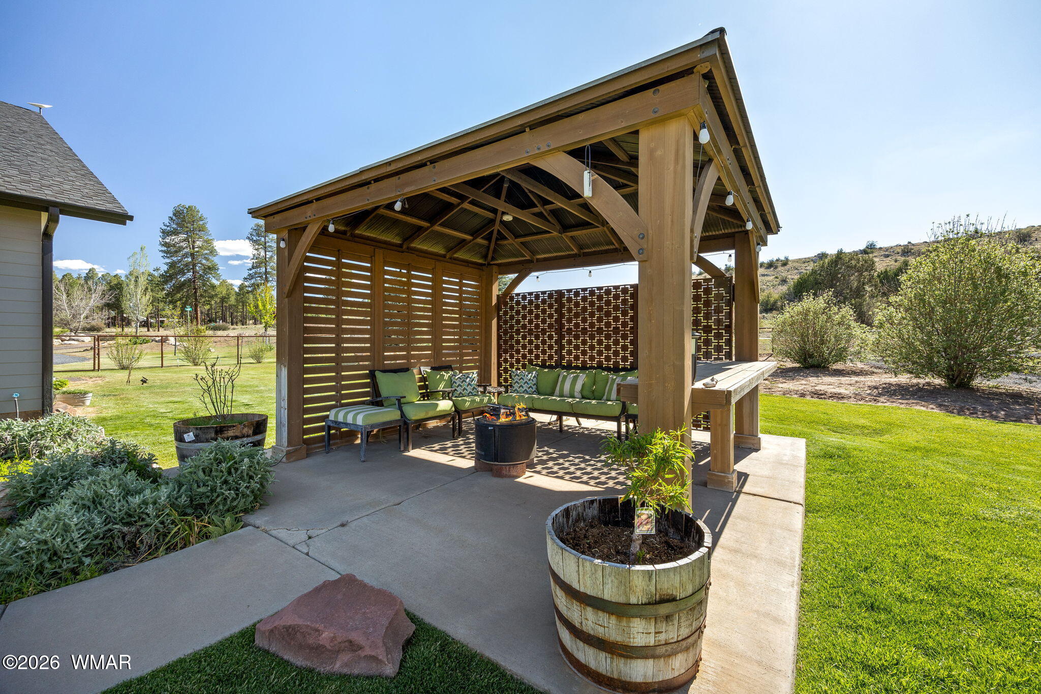 1940 Stonegate Way Heber, AZ 85928 - Photo 49 of 62 a backyard of a house with table and chairs potted plants with sky view