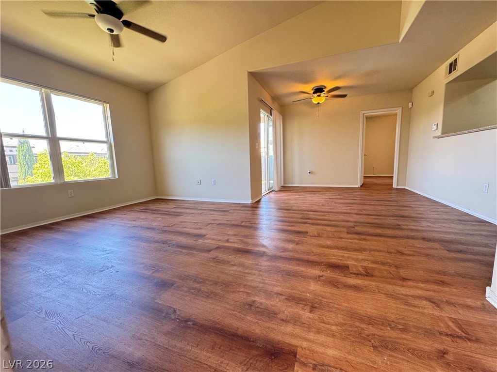 7255 West Sunset Road, Unit 2111 Las Vegas, NV 89113 - Photo 3 of 33 Rich hardwood-style flooring extends across an airy living space with ample natural light.