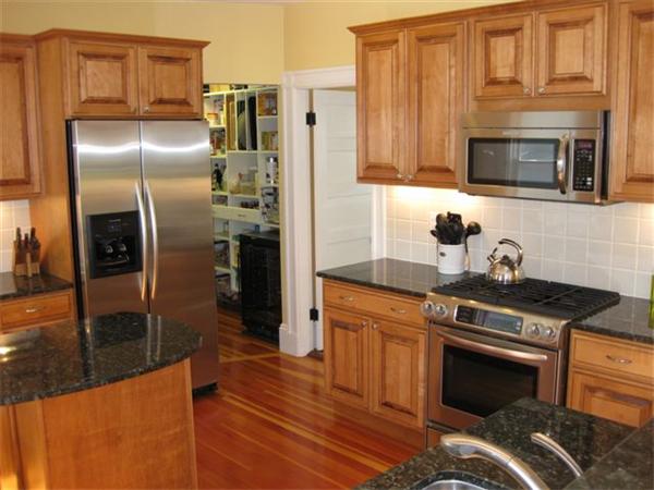 a kitchen with granite countertop a refrigerator stove and washer