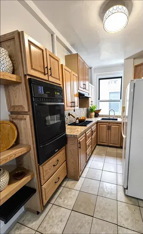 a kitchen with a refrigerator a stove and a sink