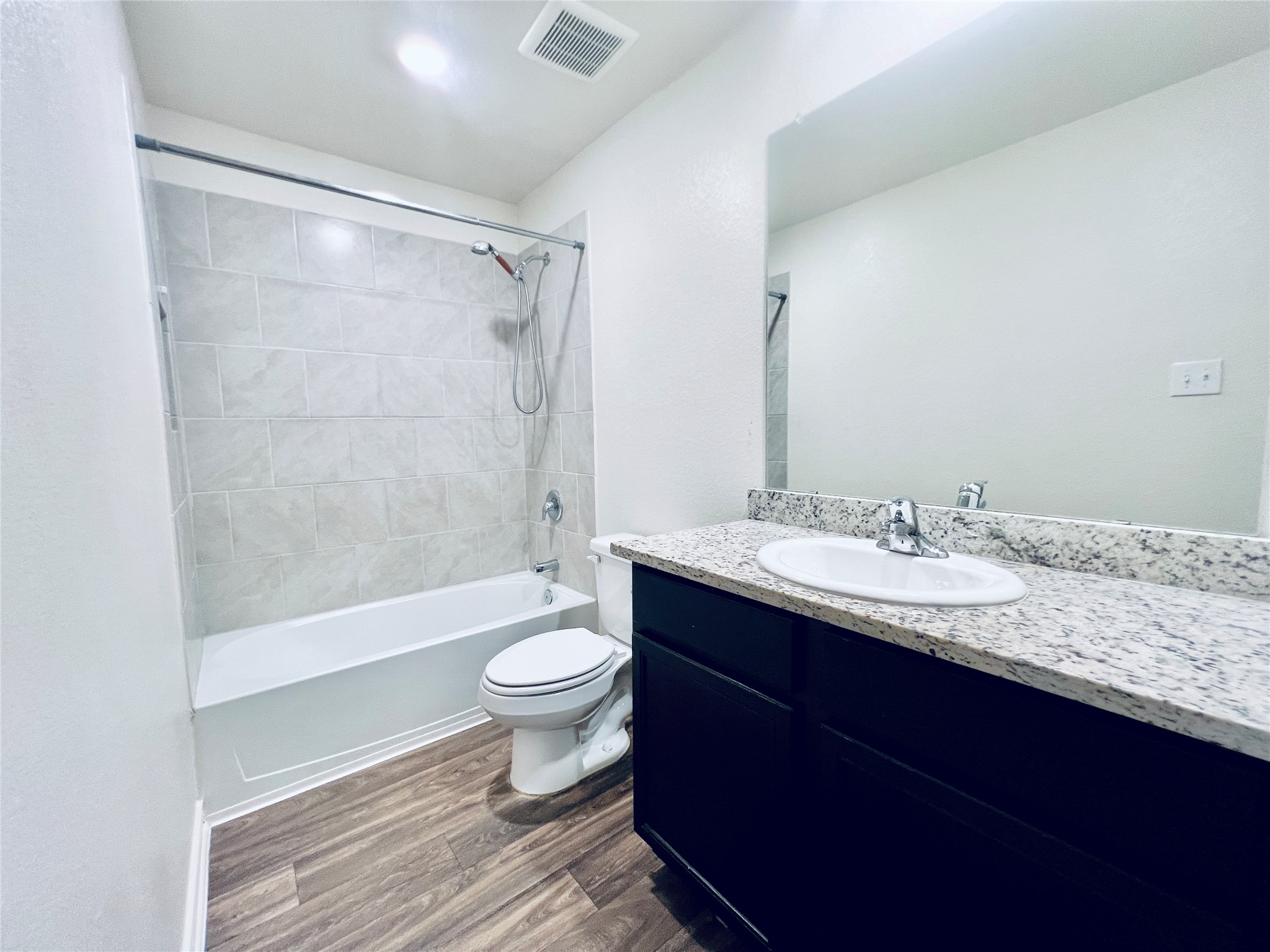 520 Locksley Cove Jarrell, TX 76537 - Photo 20 of 27 A well-appointed bathroom features a spacious bathtub and a vanity with a granite countertop.