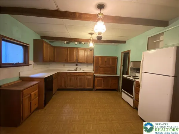 a kitchen with stainless steel appliances a refrigerator and a sink
