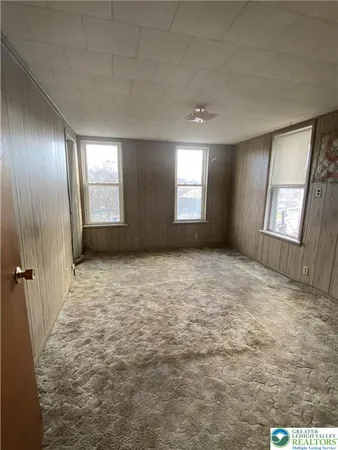 a view of an empty room with windows