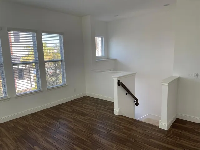 a view of an entryway with wooden floor and stairs