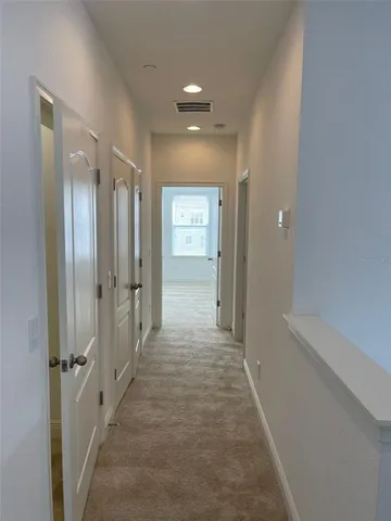 an empty room with closet and a bathroom