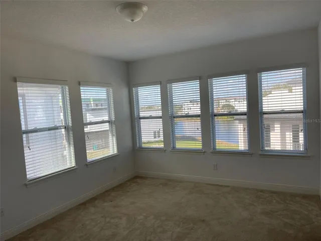 a view of an empty room with a kitchen