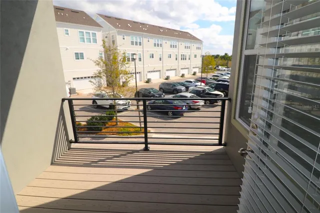a front view of a building with a garden and plants